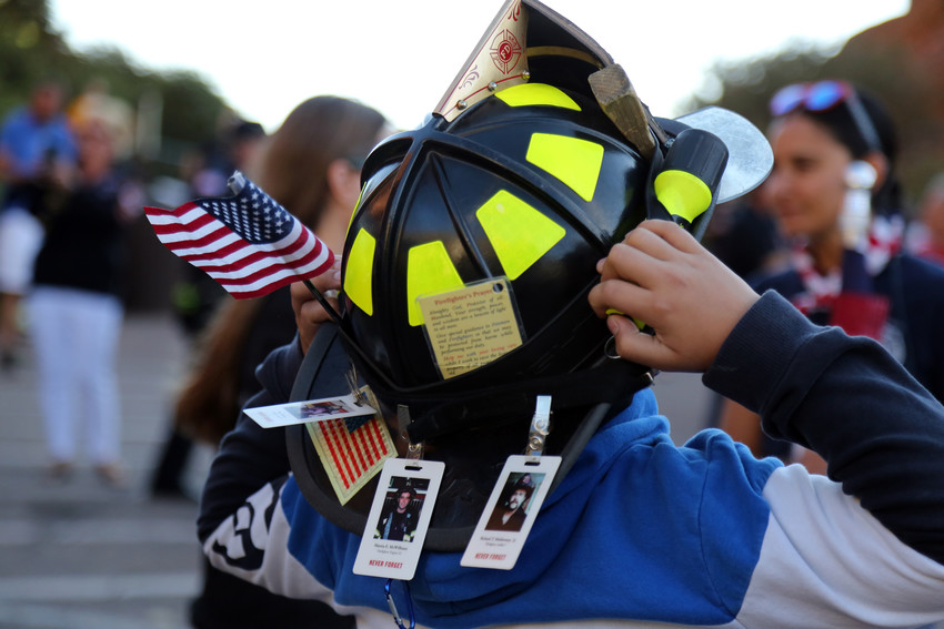 Xavier Alvarez, 11, decorated his father’s fire helmet with the firefighters prayer, the American Flag, and photos of firefighters killed on Sept. 11, 2001.